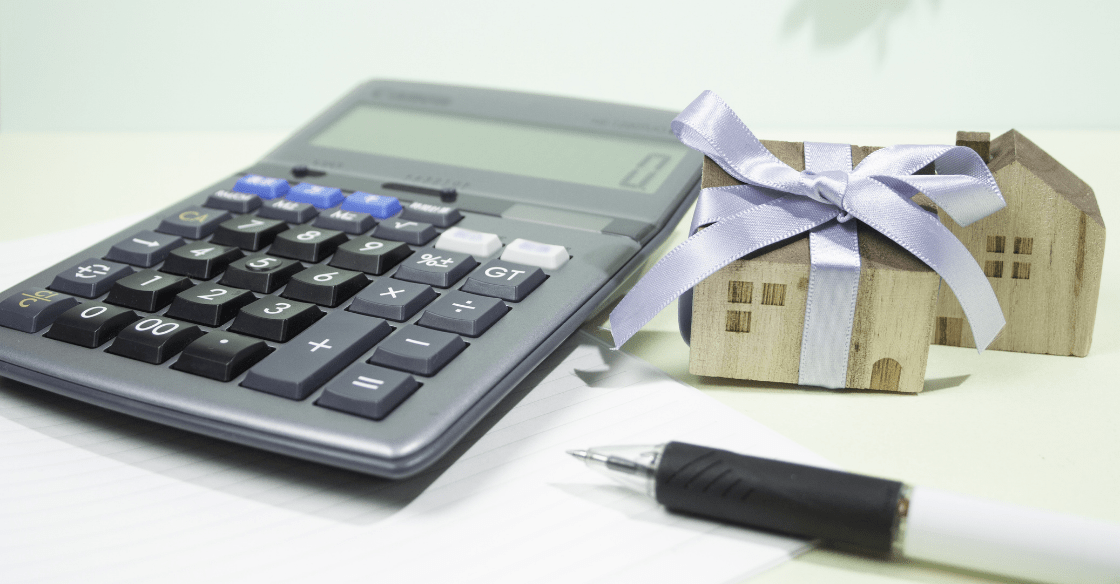 calculator with pen, real estate mini houses